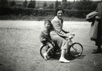Michel rides on a bicycle behind his aunt, Paulina Trocki when she came to visit him in hiding.