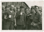 Survivors of a Kaufering camp [perhaps Landsberg] pose with American soldiers after liberation.