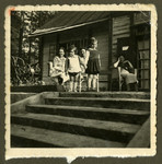 Members of the Bagriansky families relax outside a summer home in Kacerginai before the war.
