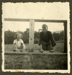 Rosian Bagriansky poses on a wooden structure with her nanny.