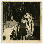 Rosian Bagriansky poses outside with her aunt Lyda Bagriansky Geist and family friends of the family [probably Rosa Govshovitz and her daughter] in either Kulautova or Kacergine Lithuania.