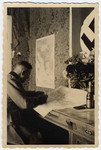 A German officer studies a map in his office.