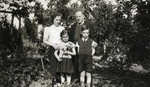 A Jewish family poses in the yard next to their home (possibly in Gagny).