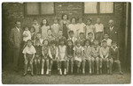 Group portrait of a class in Hildeshein.

Doris Edelman (Nee Tager) is pictured third from the right in the top row.