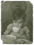 A young boy drinks from a large cup in Chateau-le-Masgelier.