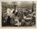 A Jewish family sits at an outdoor table near the Vitosha Mountains.