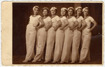 A Maccabi gymnastic team poses standing in a row in sailor costumes.