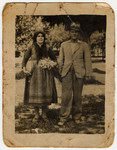 A Jewish woman, dressed in typical Greek costume, poses with her brother while hiding in the Greek countryside.