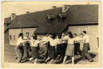 Young people dance a hora in the Kibbutz LaNegev Hachshara in the Hessisch-Lichtenau displaced persons' camp.