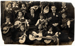 Group portrait of girls with mandolins and a guitar.
