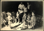Children sit in a circle in a classroom in the Nos Petits kindergarten.