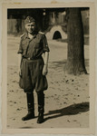 Portrait of SS officer Karl Hoecker with his sleeves rolled up standing in front of an air-raid shelter.