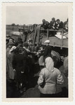 Displaced persons prepare to emigrate, assisted by members of the U.S.