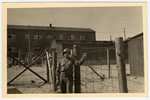 An American soldier poses in front of a fence in Buchenwald concentration camp.