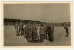 A group of liberating U.S. Army soldiers speak with prisoners in the Buchenwald concentration camp.
