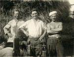 Avraham Koviliak (right) and two other men work on a farm.