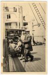 Leo Kaelbermann walks on the deck of a ship bound for the United States with his two young daughters.