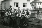 Jewish workers [probably in the Novaky camp] pose outside the wood workshop.