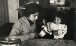 Ada Nissim sits with her young daughter Leah in their kitchen in Trieste.