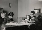 Shaul, Ada and Leah Nissim sit in the dining room of their home in Padua.