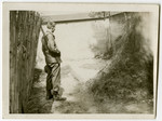U.S. soldier Clarence E. Alberg inspects an execution site in the Dachau concentration camp.
