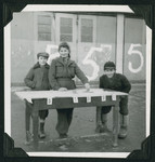 Three children stand by an election table for the World Zionist Organization at the Wetzlar displaced persons camp.