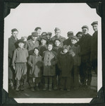 A member of the Frankfurt Jewish GI Council poses with children and adults at the Wetzlar displaced persons camp.
