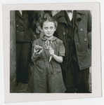 A young girl in the Ziegenhain displaced persons camp shows off her dinner.