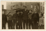 UNRRA director Mordecai Schwartz poses with a group of boys in the Aschaffenburg displaced persons' camp.