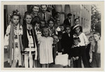 Group portrait of young children, many in national costumes, who await repatriation from Berlin to the U.S.