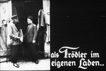 10th Nazi propaganda slide of a Hitler Youth educational presentation entitled "Germany Overcomes Jewry."

als Trödler im eigenen Laden..