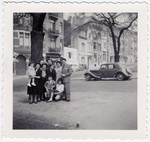 Postwar family photograph of the Sephiha family standing on a sidewalk in Brussels.