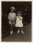 Two young children pose together in a garden in Bremen.