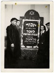A Jewish family visits the graves of their family members after the war.