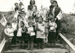 Young children carry small bags and flags during a Simchat Torah celebration in the Schlachtensee displaced persons camp.