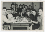 A group of women gather for a festive meal in the Bergen-Belsen displaced persons camp.