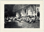Zionist youth sit in the grass at their summer camp for a group discussion.