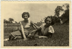 Peska Tau and Mali Froelich lying in the grass in Vijnita.