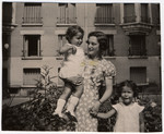 Julie van Weenen poses with her two young cousins Manuela and Jacqueline Mendels outside the girls' Paris apartment.