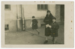 Therese Morawetz walks down a street with her two sons, Walter and Hans.