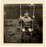 Martin Wertheim sits on a swing in a garden in Bissendorf shortly before he left on the Kindertransport.