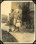 Martin and Ernst Wertheim pose outside their family home with their housekeeper.