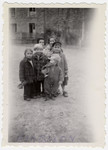 Group portrait of young children, many holding toys, at the Barbizon children's home near Paris.