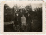 Group portrait of two sets of siblings standing on the grounds of the Chateau des Morelles children's home.