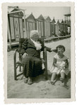 Clotilde Coen Nacamu rests on the  Ancona beach with her granddaughter Paola Ducly.