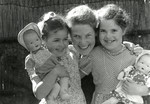 Eva Tikotin hugs her two young daughters, Johanna and Leentje, prior to their going into hiding.