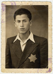 Studio portrait of Erno Pollak wearing a Jewish star.