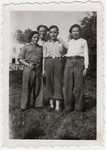 Portrait of three teenage boys and a counselor in the OSE home of either Ambloy or Taverny.