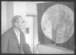 Rudolf Hess studies a poster of the moon in Spandau prison.