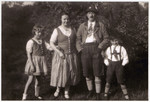 From left to right stand Ilse, Frieda, Max, and Hans Heinz in their Lederhosen and Dirndls.